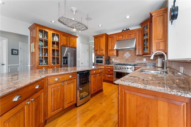 1002 Sunset Way, Menallen Twp, PA 15401 - kitchen featuring premium appliances, under cabinet range hood, beverage cooler, brown cabinetry, and light wood finished floors