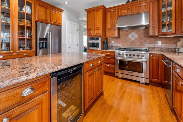 1002 Sunset Way, Menallen Twp, PA 15401 - kitchen featuring high end appliances, under cabinet range hood, wine cooler, light wood finished floors, and light stone counters