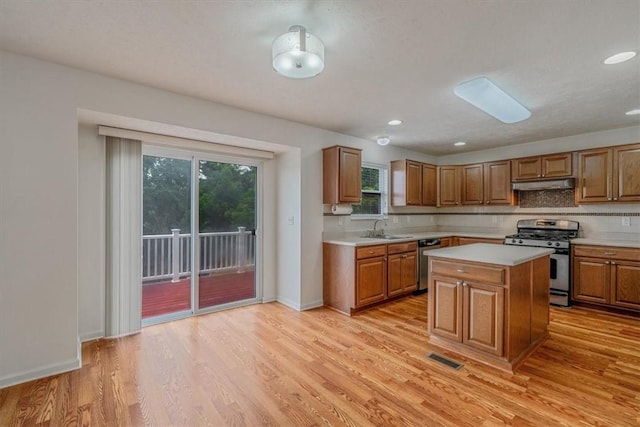 520 Panorama Dr, Cecil, PA 15317 - kitchen with appliances with stainless steel finishes, under cabinet range hood, light countertops, light wood-style floors, and recessed lighting
