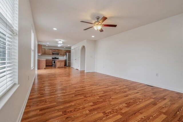 520 Panorama Dr, Cecil, PA 15317 - unfurnished living room featuring a ceiling fan, light wood-type flooring, arched walkways, and recessed lighting