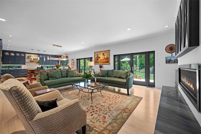 2356 Morrow Rd, Upper St Clair, PA 15241 - living area featuring healthy amount of natural light, a glass covered fireplace, wood finished floors, and recessed lighting