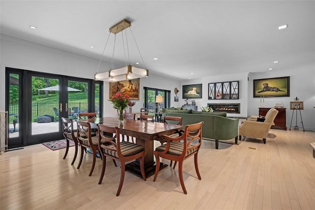 2356 Morrow Rd, Upper St Clair, PA 15241 - dining room with light wood-type flooring, recessed lighting, and a glass covered fireplace