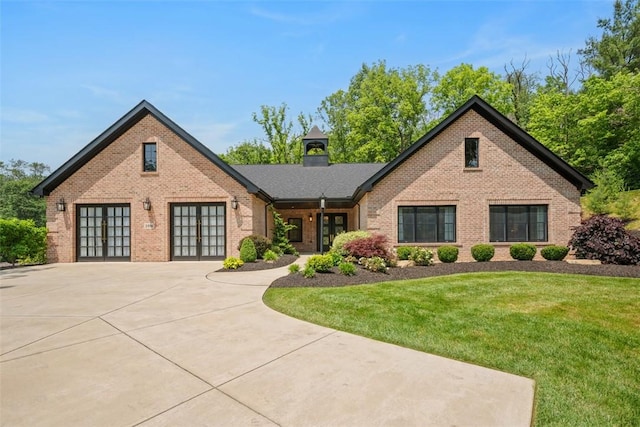 2356 Morrow Rd, Upper St Clair, PA 15241 - english style home with french doors, brick siding, a front lawn, and a chimney