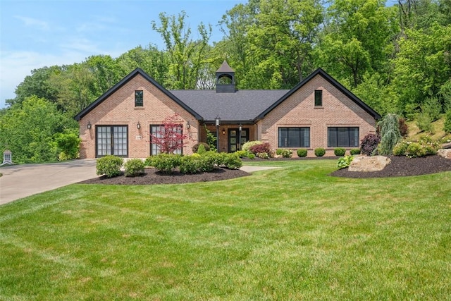 2356 Morrow Rd, Upper St Clair, PA 15241 - tudor-style house featuring brick siding, a front lawn, and driveway