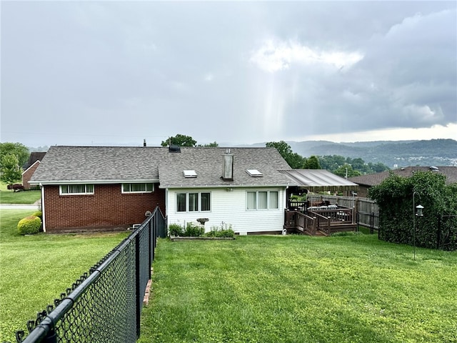 240 Reed St, Lower Burrell, PA 15068 - back of house with a fenced backyard, roof with shingles, and a deck with mountain view