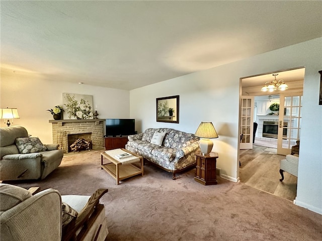 240 Reed St, Lower Burrell, PA 15068 - living room with a fireplace, carpet flooring, and a chandelier