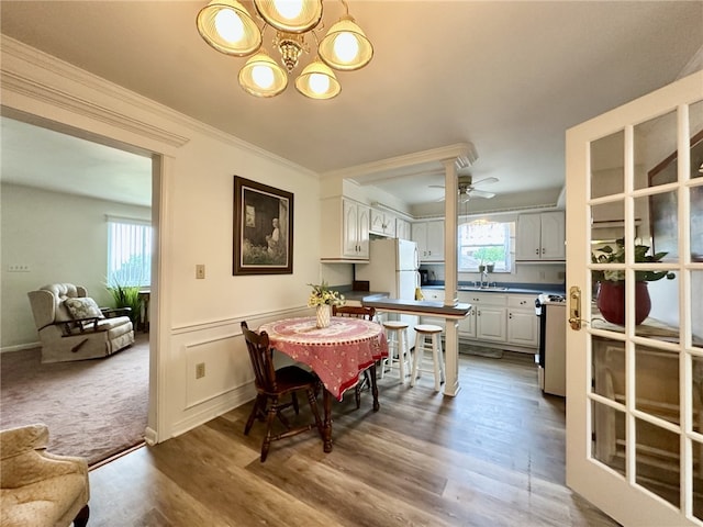 240 Reed St, Lower Burrell, PA 15068 - dining space featuring ornamental molding, a ceiling fan, wood finished floors, and a chandelier