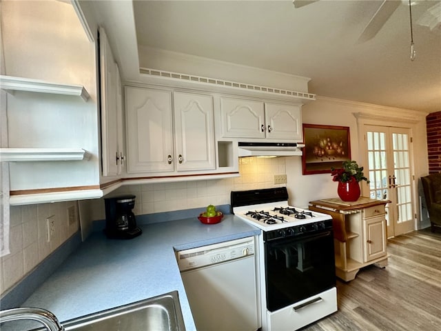 240 Reed St, Lower Burrell, PA 15068 - kitchen featuring white appliances, under cabinet range hood, white cabinetry, decorative backsplash, and ornamental molding