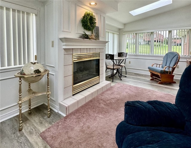 240 Reed St, Lower Burrell, PA 15068 - living room with wood finished floors, a skylight, a fireplace, and lofted ceiling