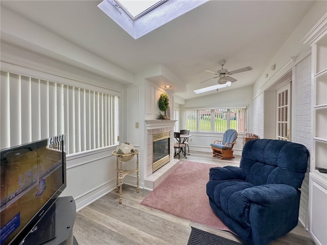 240 Reed St, Lower Burrell, PA 15068 - living area with a skylight, wood finished floors, a fireplace, ceiling fan, and lofted ceiling