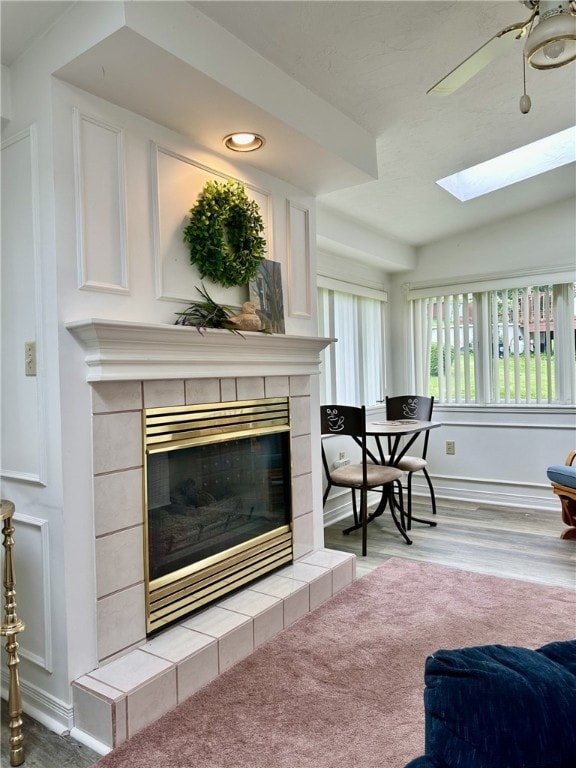 240 Reed St, Lower Burrell, PA 15068 - living room featuring a fireplace, wood finished floors, a skylight, and recessed lighting