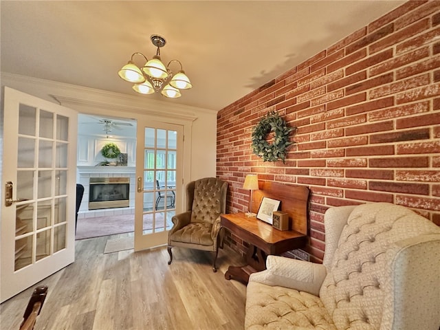 240 Reed St, Lower Burrell, PA 15068 - living area with a glass covered fireplace, ceiling fan, wood finished floors, a chandelier, and crown molding