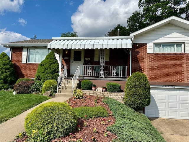 240 Reed St, Lower Burrell, PA 15068 - ranch-style home featuring brick siding, a porch, an attached garage, and driveway