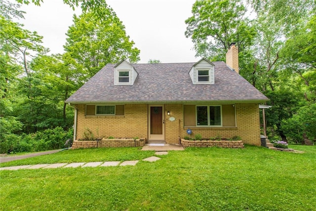 670 Lougeay Rd, Penn Hills, PA 15235 - cape cod home with a chimney, a front yard, brick siding, and roof with shingles