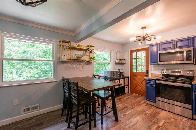 670 Lougeay Rd, Penn Hills, PA 15235 - kitchen featuring stainless steel appliances, blue cabinetry, backsplash, a chandelier, and wood finished floors