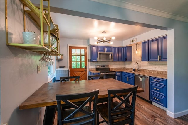 670 Lougeay Rd, Penn Hills, PA 15235 - kitchen with stainless steel appliances, blue cabinetry, a chandelier, decorative backsplash, and ornamental molding
