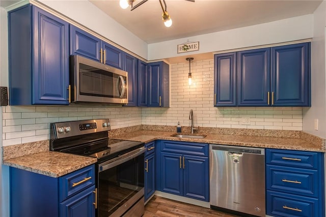 670 Lougeay Rd, Penn Hills, PA 15235 - kitchen with appliances with stainless steel finishes, blue cabinetry, and tasteful backsplash