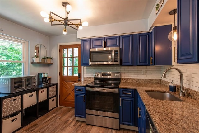 670 Lougeay Rd, Penn Hills, PA 15235 - kitchen featuring stainless steel appliances, blue cabinetry, tasteful backsplash, and a chandelier