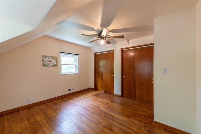 670 Lougeay Rd, Penn Hills, PA 15235 - unfurnished bedroom featuring multiple closets, wood finished floors, lofted ceiling, and ceiling fan