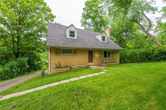 670 Lougeay Rd, Penn Hills, PA 15235 - new england style home featuring brick siding, a chimney, a front lawn, and a shingled roof