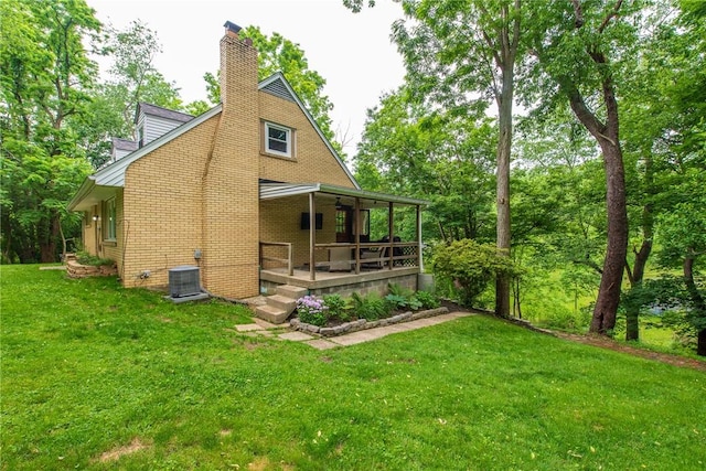 670 Lougeay Rd, Penn Hills, PA 15235 - rear view of property with a lawn, a chimney, a porch, and brick siding