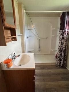 325 Back St, Mount Pleasant Twp Wml, PA 15666 - bathroom with vanity, curtained shower, and wood finished floors