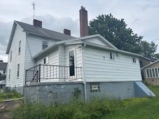 325 Back St, Mount Pleasant Twp Wml, PA 15666 - view of property exterior with a chimney
