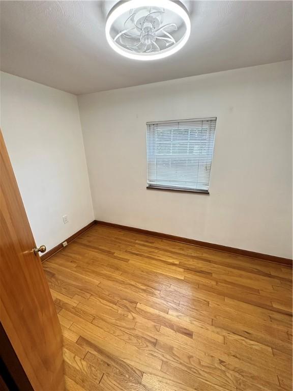 7207 Mcclure Ave, Swissvale, PA 15218 - empty room with light wood-style floors and baseboards
