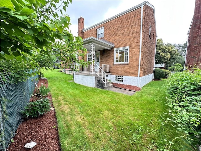 7207 Mcclure Ave, Swissvale, PA 15218 - back of house featuring brick siding and a chimney