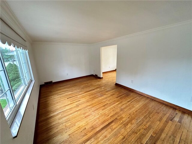 7207 Mcclure Ave, Swissvale, PA 15218 - empty room featuring light wood-type flooring and ornamental molding
