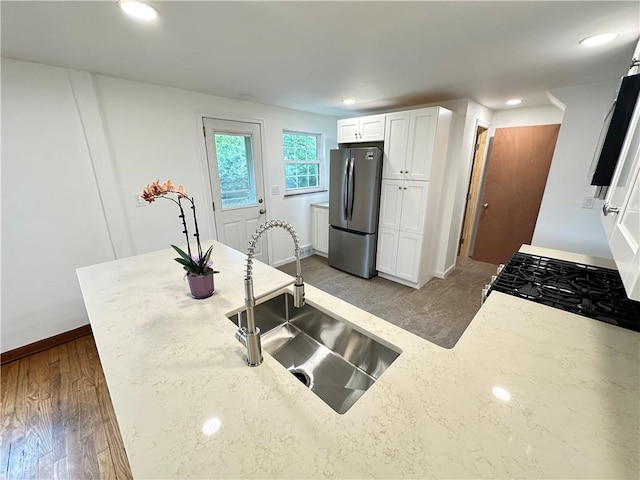 7207 Mcclure Ave, Swissvale, PA 15218 - kitchen with stainless steel appliances, light stone counters, white cabinets, and recessed lighting