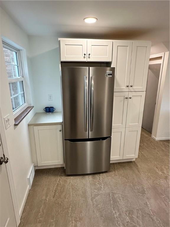 7207 Mcclure Ave, Swissvale, PA 15218 - kitchen with freestanding refrigerator, white cabinetry, and recessed lighting
