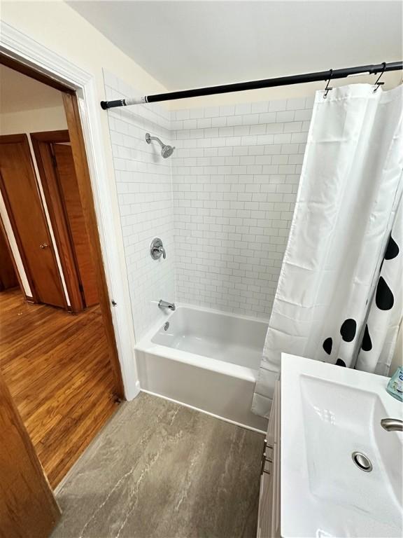 7207 Mcclure Ave, Swissvale, PA 15218 - full bathroom with shower / bathtub combination with curtain, vanity, and wood finished floors