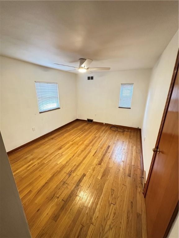 7207 Mcclure Ave, Swissvale, PA 15218 - spare room featuring light wood-style floors, a ceiling fan, and healthy amount of natural light