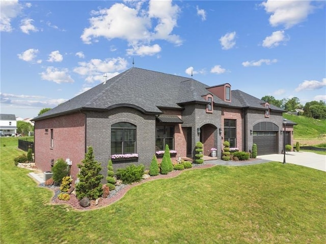 7858 Oscar Ct, North Huntingdon, PA 15642 - french provincial home with brick siding, concrete driveway, a front lawn, and roof with shingles