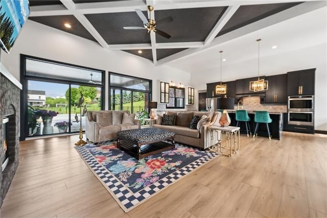 7858 Oscar Ct, North Huntingdon, PA 15642 - living room featuring coffered ceiling, light wood-style floors, a ceiling fan, a high ceiling, and beam ceiling