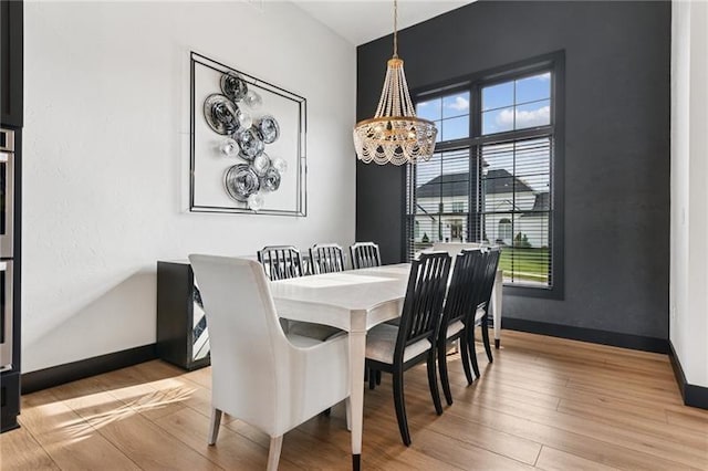 7858 Oscar Ct, North Huntingdon, PA 15642 - dining space featuring a chandelier and light wood-style floors