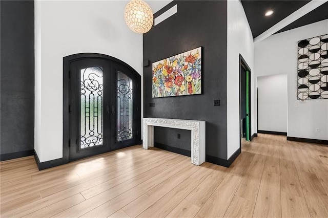 7858 Oscar Ct, North Huntingdon, PA 15642 - entryway with arched walkways, french doors, light wood-style flooring, and a high ceiling