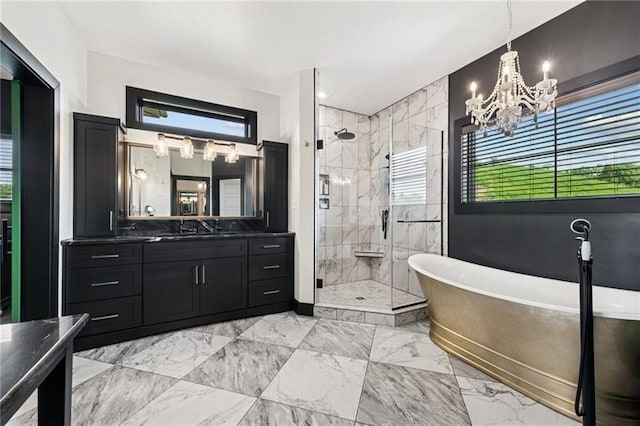 7858 Oscar Ct, North Huntingdon, PA 15642 - bathroom featuring vanity, a shower stall, a freestanding bath, a chandelier, and marble look tiles