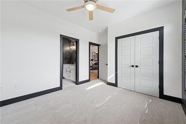 7858 Oscar Ct, North Huntingdon, PA 15642 - unfurnished bedroom featuring light carpet, a closet, ceiling fan, and connected bathroom
