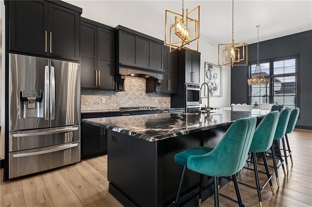 7858 Oscar Ct, North Huntingdon, PA 15642 - kitchen with stainless steel appliances, a chandelier, and dark cabinets