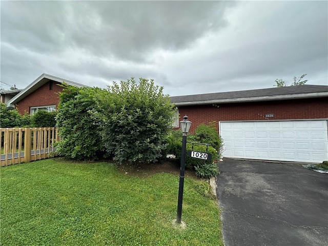 1020 Grove St, Hempfield Twp Wml, PA 15601 - view of front facade with brick siding, asphalt driveway, and a garage