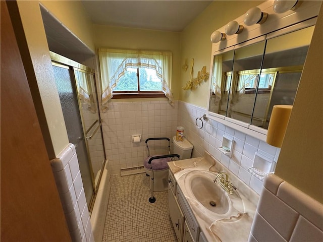 1020 Grove St, Hempfield Twp Wml, PA 15601 - bathroom with tile walls, vanity, bath / shower combo with glass door, wainscoting, and tile patterned floors