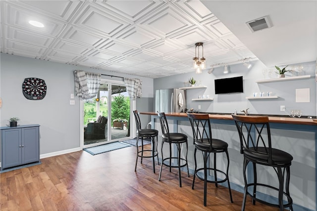 161 Buckingham Dr, Ohio Twp, PA 15237 - kitchen featuring butcher block counters, open shelves, freestanding refrigerator, an ornate ceiling, and a kitchen bar