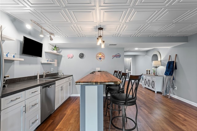 161 Buckingham Dr, Ohio Twp, PA 15237 - kitchen featuring stainless steel dishwasher, open shelves, butcher block countertops, a breakfast bar, and track lighting