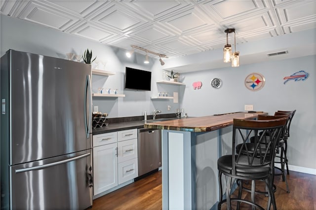 161 Buckingham Dr, Ohio Twp, PA 15237 - kitchen featuring stainless steel appliances, butcher block counters, open shelves, a breakfast bar area, and an ornate ceiling