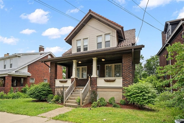 3341 Beacon Hill Ave, Dormont, PA 15216 - view of front of house with a porch, brick siding, and a front yard