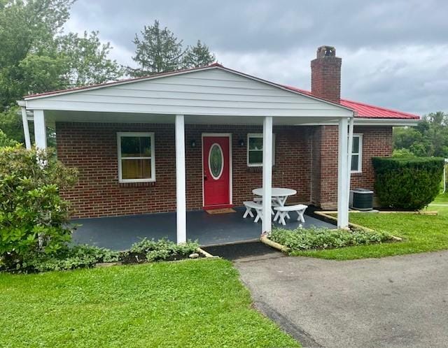 82 Crossridge, Crossridge, PA 15022 - view of front of property with a chimney, a front lawn, and brick siding