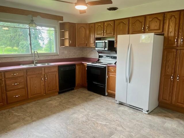 82 Crossridge, Crossridge, PA 15022 - kitchen with freestanding refrigerator, black dishwasher, range with electric stovetop, stainless steel microwave, and brown cabinets