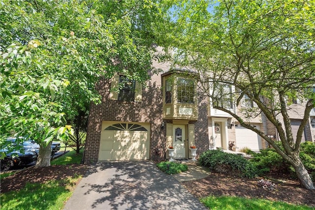 617 Woodcrest Dr, Robinson Twp Nwa, PA 15205 - view of front facade featuring brick siding, driveway, and an attached garage